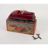SCHUCO BOXED RADIO 4012 CLOCKWORK TINPLATE TWO SEATER CAR, maroon with red interior, lacks metal