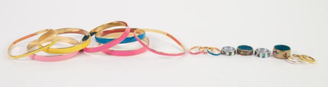 FIVE GILT METAL AND HARLEQUIN ENAMELLED BANGLES; TWO NARROWER, SIMILAR BANGLES and SIX GILT METAL