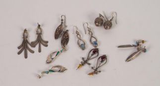 PAIR OF SILVER EARRINGS each set with an oval turquoise having a feather pattern drop and SIX