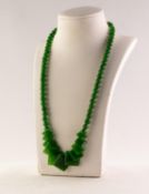 SINGLE STRAND NECKLACE of graduated round jade green coloured hardstone beads, the front with eleven