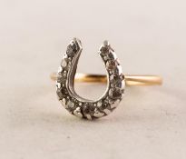 VICTORIAN GOLD COLOURED METAL RING, the horseshoe shaped top set with eleven old cut small diamonds,