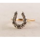 VICTORIAN GOLD COLOURED METAL RING, the horseshoe shaped top set with eleven old cut small diamonds,
