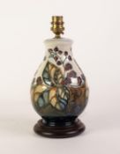 MODERN MOORCROFT POTTERY SWOLLEN BALUSTER SHAPE ELECTRIC TABLE LAMP with wooden base, tube lined