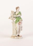 GERMAN PORCELAIN ALLEGORICAL FEMALE FIGURE, modelled standing beside a pedestal and holding a