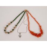 NECKLACE OF TRANSLUSCENT ORANGE HARDSTONE BEADS, 18in (46cm) long; a NECKLACE of green hardstone,