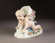 LATE 19th CENTURY GERMAN PORCELAIN POSY HOLDER in the form of a cherub in crawling posture, a basket