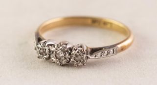 18ct GOLD AND PLATINUM RING with three small diamonds in deceptive settings, 0.05ct in total, 2.6