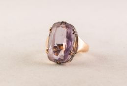 GOLD COLOURED METAL RING with an oval amethyst, in six claw setting, 4.8 gms