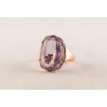 GOLD COLOURED METAL RING with an oval amethyst, in six claw setting, 4.8 gms