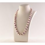 SINGLE STRAND NECKLACE OF UNIFORM CULTURED PEARLS, with chip amethyst spacers, 18in (45.7cm) long