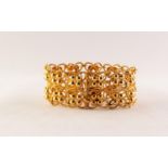 ITALIAN GOLD COLOURED METAL BROAD OPENWORK BRACELET with two rows of quatrefoil links, each with a