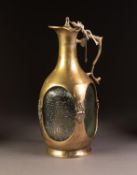 HEAVY BRASS MOUNTED AND ENCASED MOULDED GLASS CLARET JUG, of square form with scroll handle and