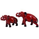 Two Royal Doulton red flambé elephants