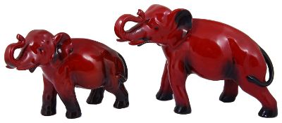Two Royal Doulton red flambé elephants