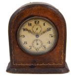 An early 20th century gilt tooled leather arched desk clock