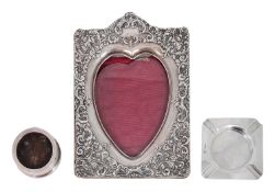 A late Vict. silver photograph frame together with a square silver ashtray and a stamp wetter