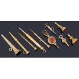A small collection of 19th c gold clad and yellow metal watch keys and propelling pencils