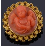 An Etruscan style carved coral cherub brooch