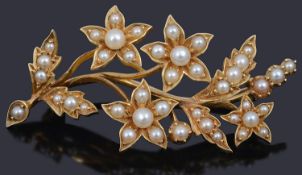 An attractive Victorian half pearl set floral spray brooch