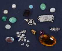 A small collection of loose diamonds and related items
