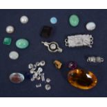 A small collection of loose diamonds and related items