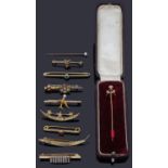 A collection of Victorian and later gold pin brooches and tie pins