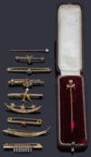 A collection of Victorian and later gold pin brooches and tie pins