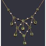 An attractive Edwardian peridot and seed pearl drop necklace