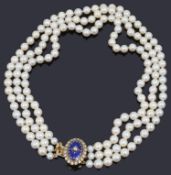 An attractive three stand cultured pearl necklace with diamond and enamel clasp