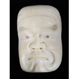 A Japanese Meiji period noh mask netsuke