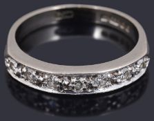 A delicate diamond set half eternity ring