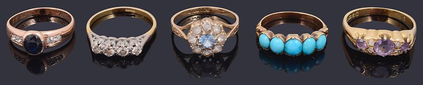 A sapphire and diamond set ring and four other rings