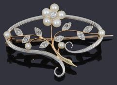 A delicate Edwardian diamond and pearl set floral scroll brooch