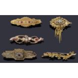 Three Victorian Etruscan style brooches and two later brooches