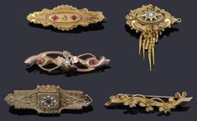 Three Victorian Etruscan style brooches and two later brooches