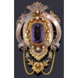 A large Continental 19th Century amethyst set scroll pendant brooch