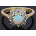 A Continental opal and diamond daisy cluster ring