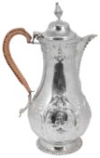 A late Victorian George III style silver hot water jug