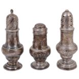 A George II silver bun top pepper pot and two George II silver ogee baluster form sugar casters