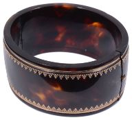 An attractive Victorian polished tortoiseshell pique bangle