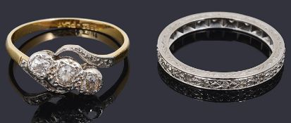 A three stone diamond set ring and a diamond set eternity ring