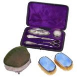 A George V silver jewellery box; a silver manicure set; one other