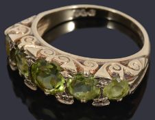 A 9ct five stone graduated peridot ring