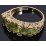 A 9ct five stone graduated peridot ring