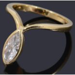 A gold single stone marquise shaped diamond ring