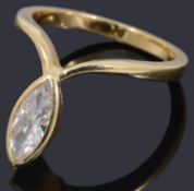 A gold single stone marquise shaped diamond ring