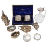 A mixed lot of silver to include an Edwardian Art Nouveau five piece cruet set and napkin rings