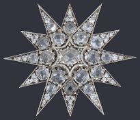 A silver and facetted paste twelve pointed star brooch