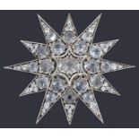 A silver and facetted paste twelve pointed star brooch