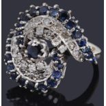 A decorative white gold sapphire and diamond stylised crossover ring
